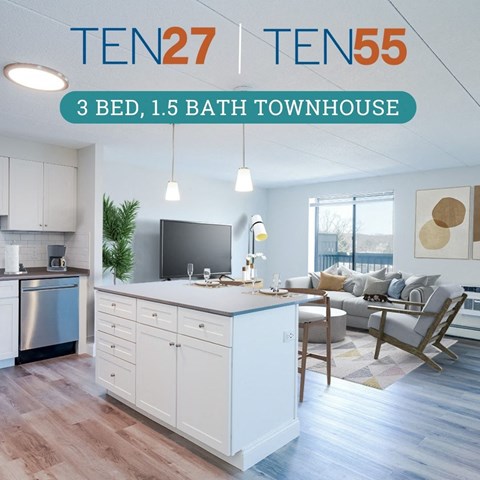 an open floor plan with a large kitchen island and a living room with a couch and a